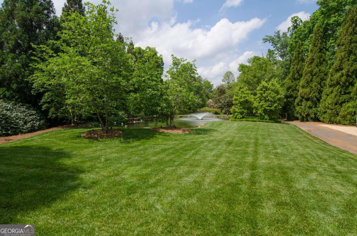 2100 West Wesley Road Northwest Atlanta, GA 30327 - Photo 8 of 53 a backyard of a house with lots of green space