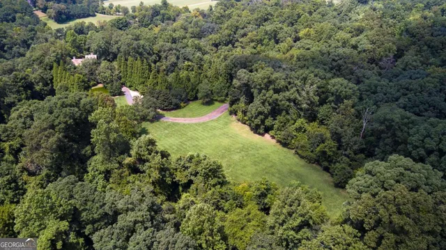 a view of a green field with wooden fence
