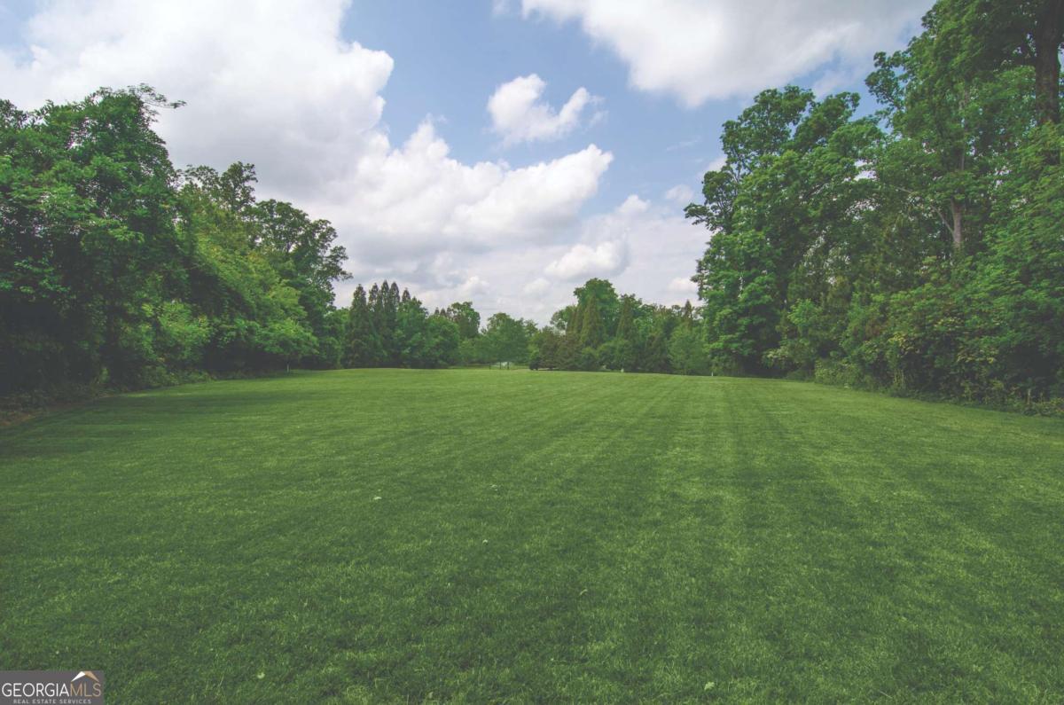 2100 West Wesley Road Northwest Atlanta, GA 30327 - Photo 10 of 53 a view of a green field with wooden fence
