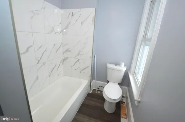 a white toilet sitting next to a white sink