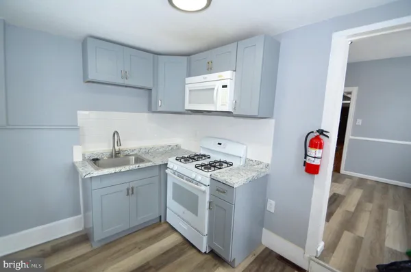 a utility room with sink dryer and washer