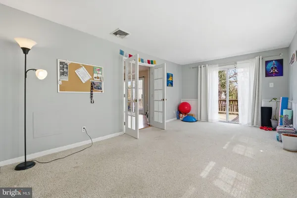 a view of an empty room with window and storage
