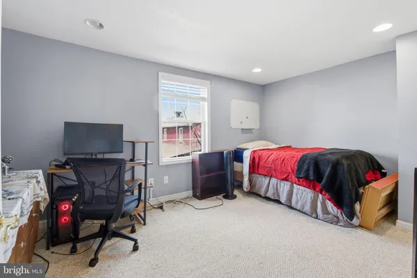 a bedroom with a bed and a chair
