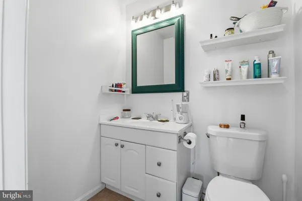 a bathroom with a toilet sink and mirror