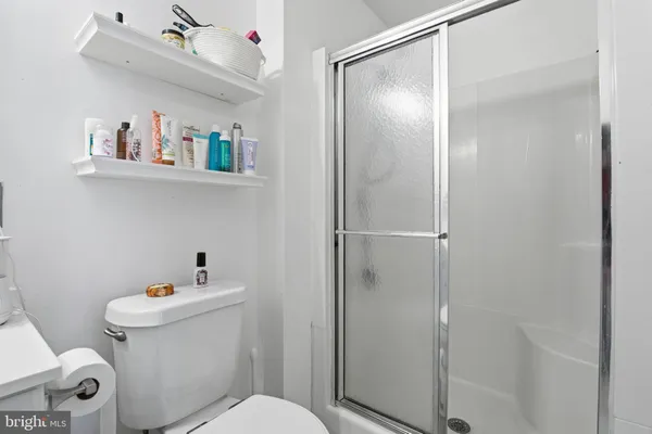 a white toilet sitting next to a bathroom sink