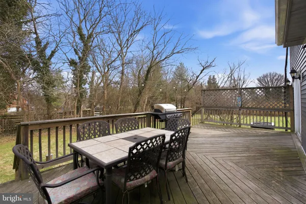 a view of a deck with furniture and wooden floor