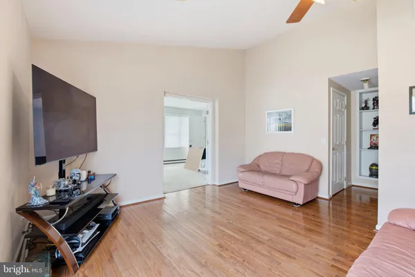 a bedroom with wooden floor and a bed