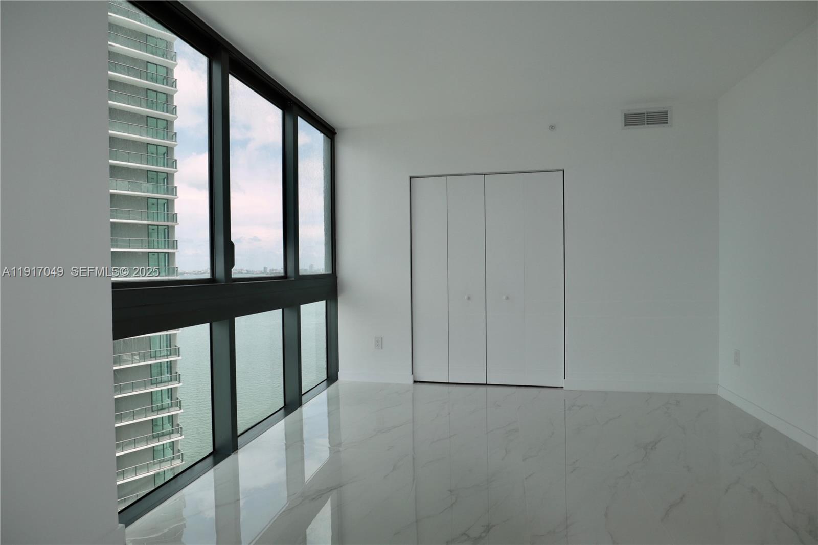 650 Northeast 32nd Street, Unit 1207 Miami, FL 33137 - Photo 9 of 30 an empty room with windows