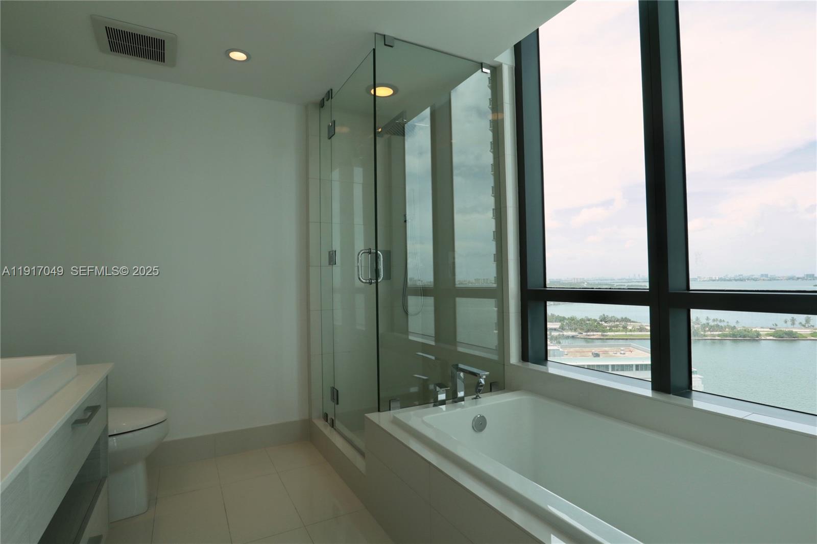 650 Northeast 32nd Street, Unit 1207 Miami, FL 33137 - Photo 10 of 30 a bathroom with a tub and a shower
