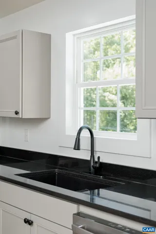 a view of a sink and cabinets in kitchen