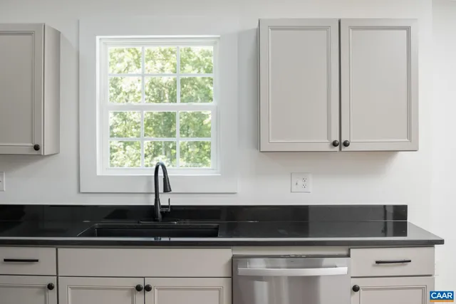 a close view of sink and cabinets