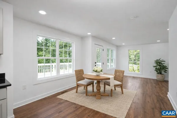 a dining room with furniture and wooden floor