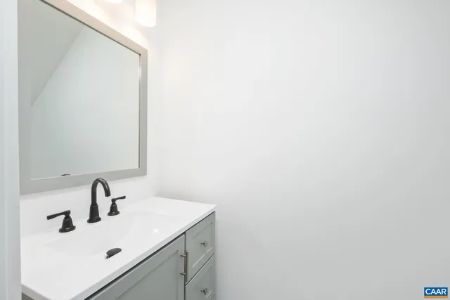 a bathroom with a sink and mirror
