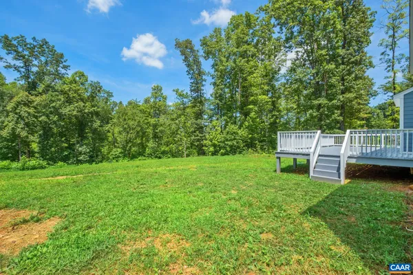 a view of a chair and table in the garden