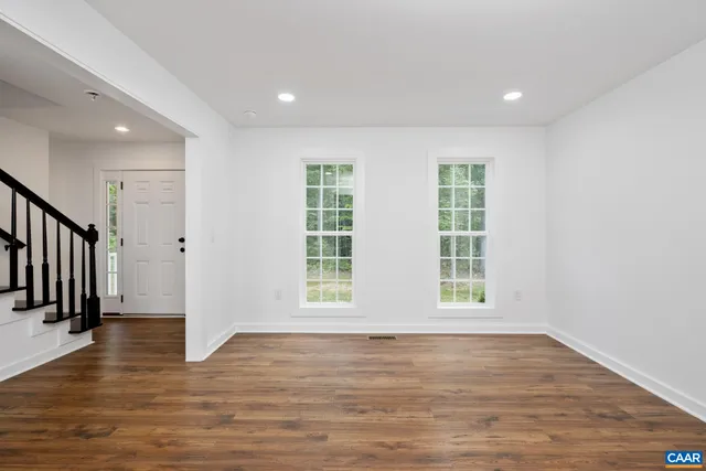 wooden floor in an empty room with a window