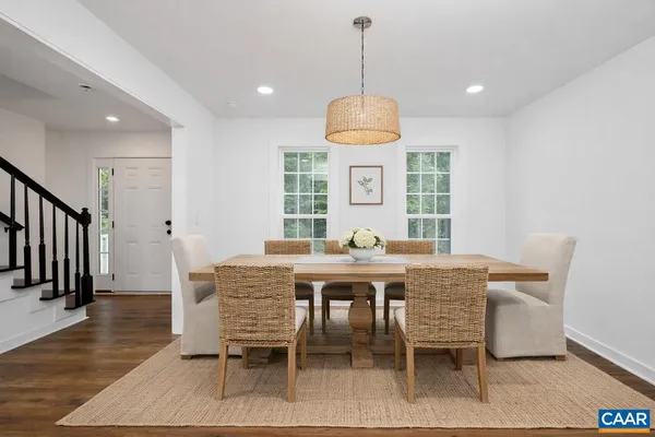 a view of a dining room with furniture wooden floor and chandelier