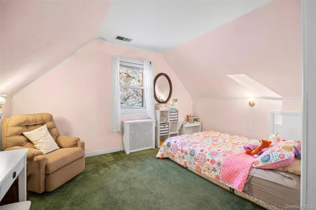 a bedroom with a bed couch and a window