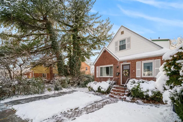 a view of a house with yard and sitting area