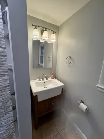 a bathroom with a sink a mirror and a toilet