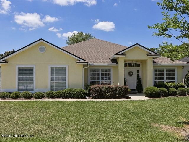 1204 Ribbon Road St. Johns, FL 32259 - Photo 1 of 26 a front view of a house with a garden