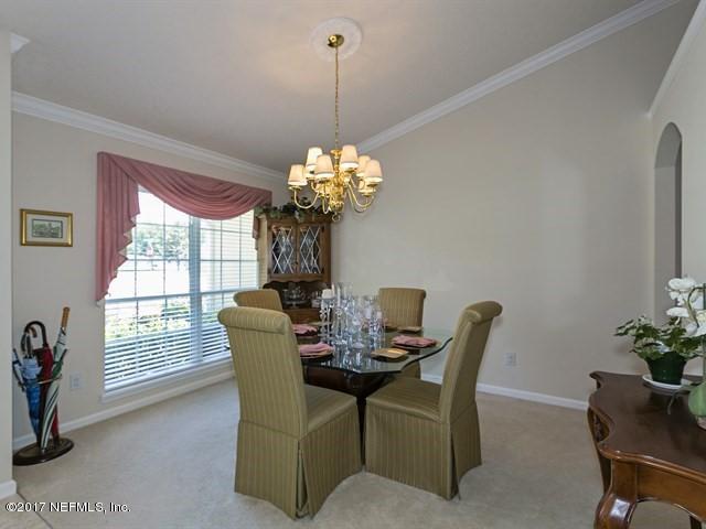 1204 Ribbon Road St. Johns, FL 32259 - Photo 2 of 26 a dining room with furniture a potted plant and a chandelier