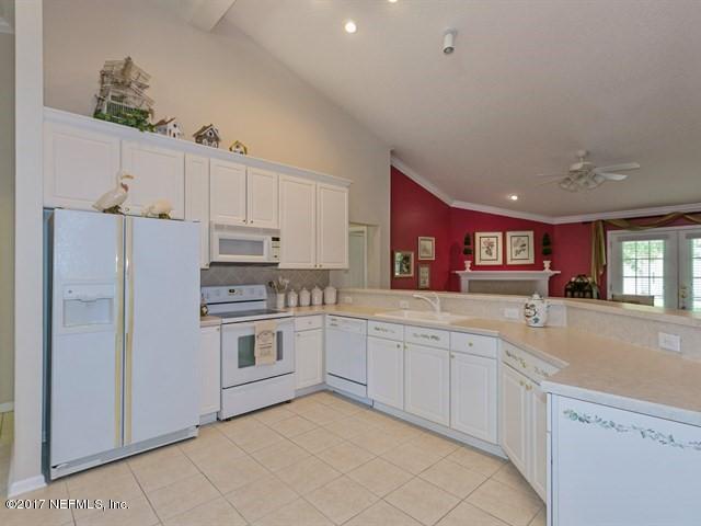 1204 Ribbon Road St. Johns, FL 32259 - Photo 5 of 26 a kitchen with granite countertop white cabinets and white appliances