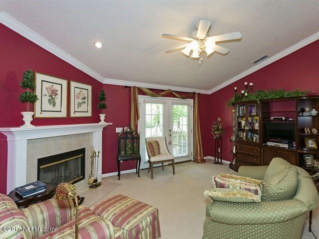 1204 Ribbon Road St. Johns, FL 32259 - Photo 7 of 26 a living room with furniture a large window and a fireplace