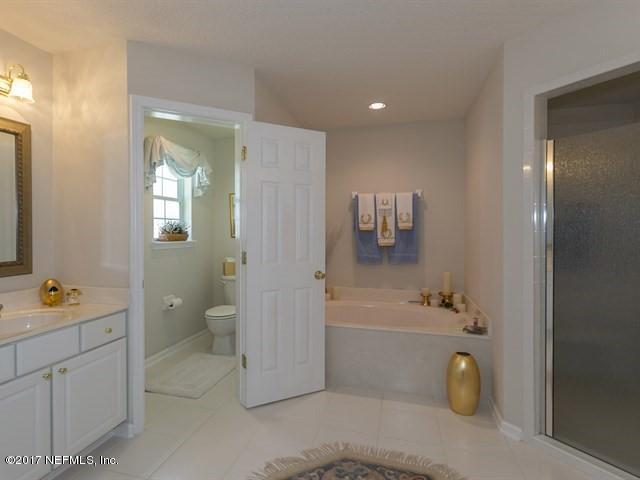 1204 Ribbon Road St. Johns, FL 32259 - Photo 10 of 26 a bathroom with a tub a toilet and a sink