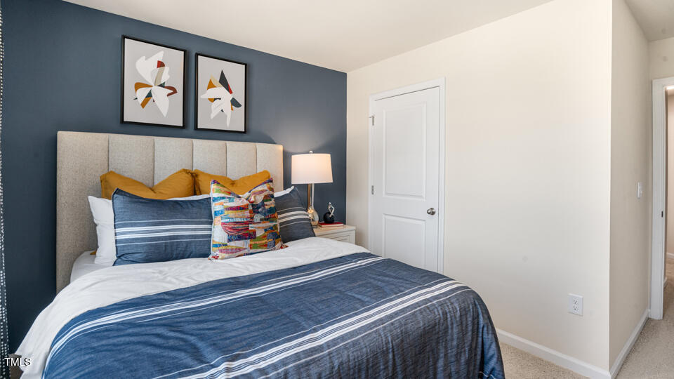 8514 Beckett Chase Way Raleigh, NC 27616 - Photo 23 of 29 a bedroom with a bed and painting on the wall