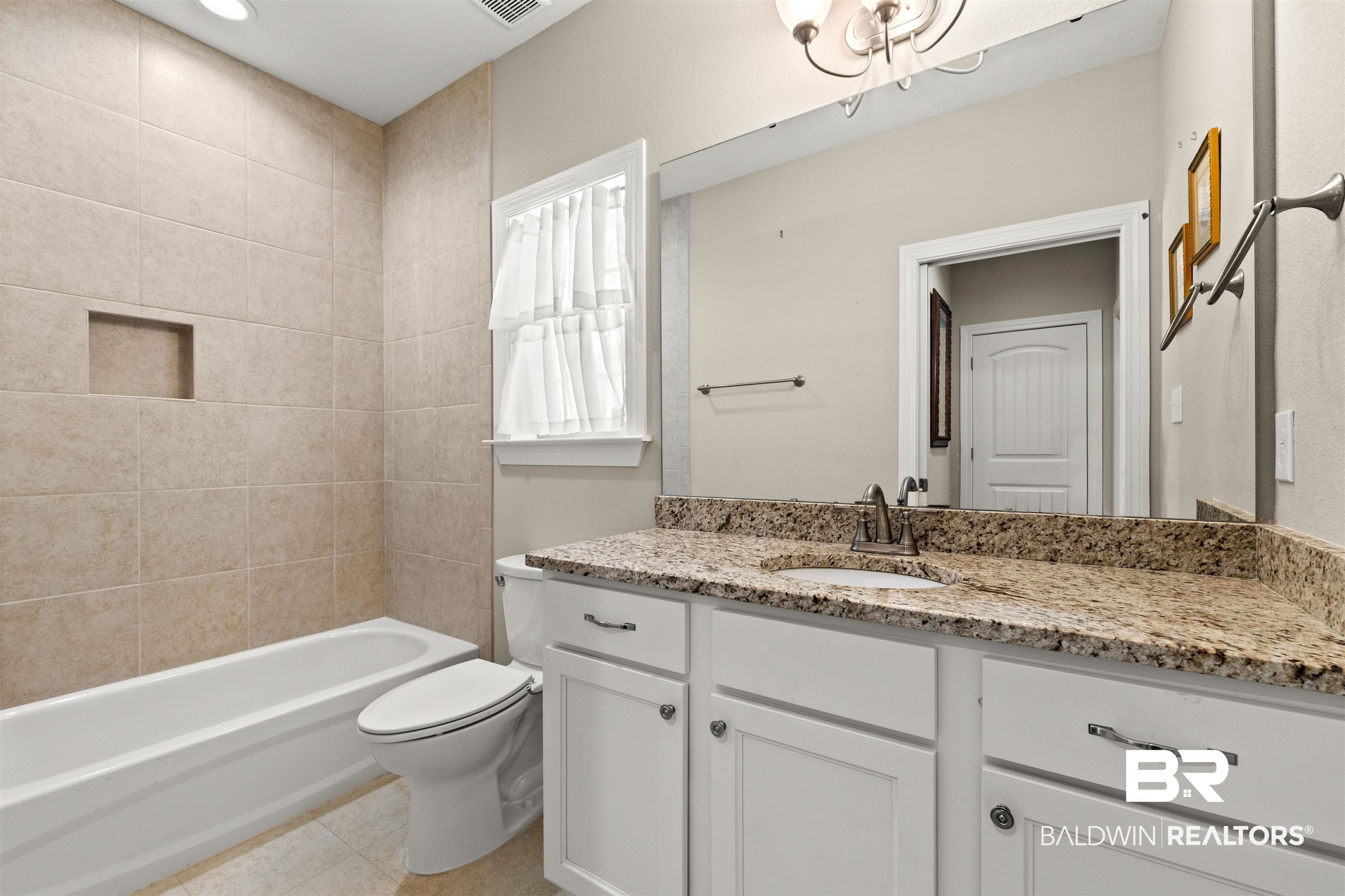 301 Holmes Avenue, Unit 301 Foley, AL 36535 - Photo 32 of 54 Full bath featuring visible vents, toilet, tile patterned flooring, shower / bath combination, and vanity