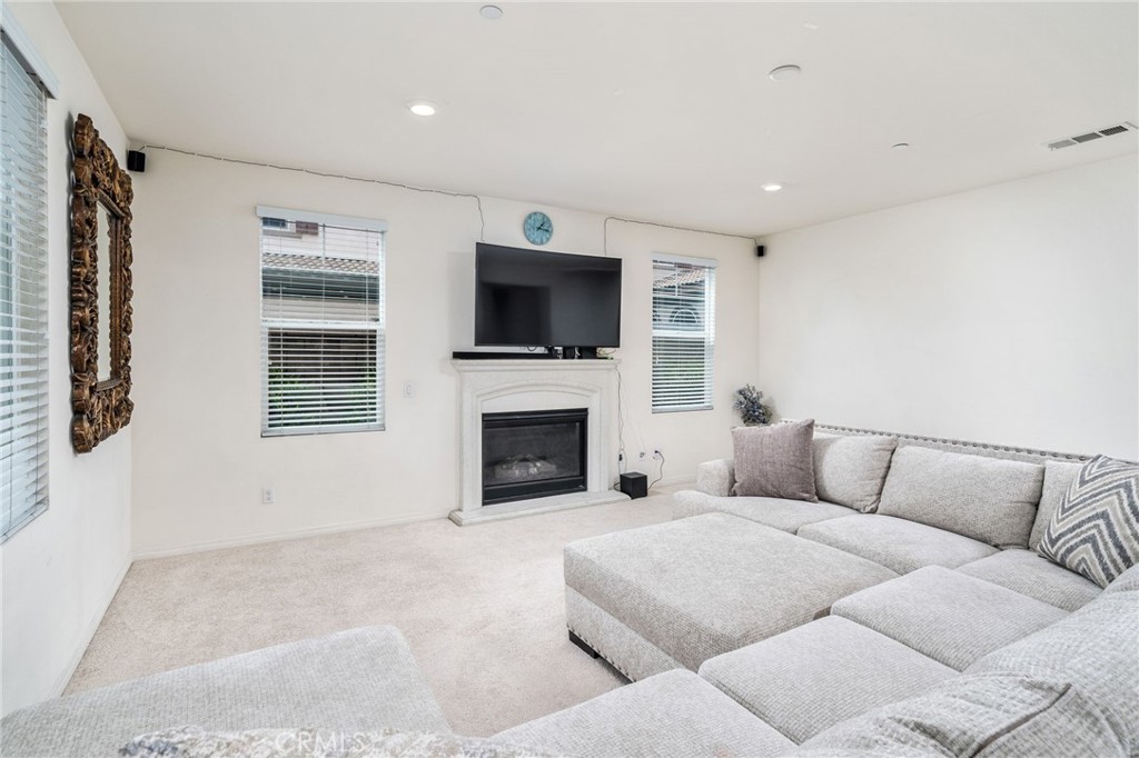 13243 Stanton Drive Rancho Cucamonga, CA 91739 - Photo 11 of 53 a living room with furniture a fireplace and a flat screen tv