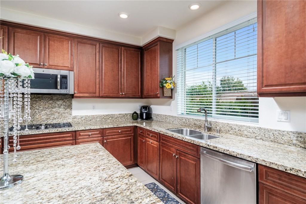 13243 Stanton Drive Rancho Cucamonga, CA 91739 - Photo 17 of 53 a kitchen with stainless steel appliances granite countertop a sink stove and cabinets