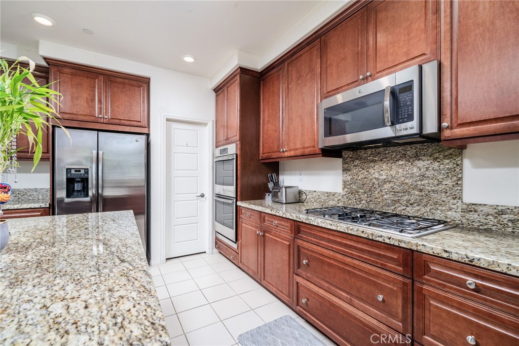 13243 Stanton Drive Rancho Cucamonga, CA 91739 - Photo 18 of 53 a kitchen with stainless steel appliances granite countertop a stove microwave and refrigerator
