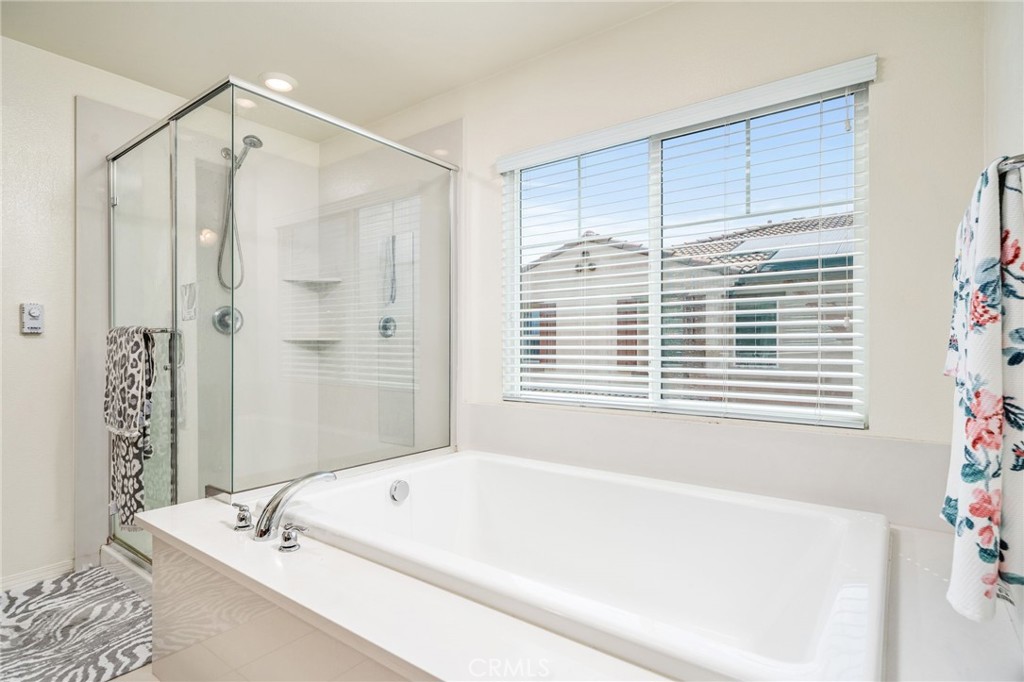 13243 Stanton Drive Rancho Cucamonga, CA 91739 - Photo 32 of 53 a bathroom with a bathtub and a shower