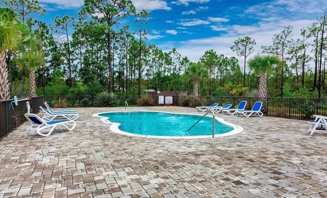 a backyard of a house with table and chairs