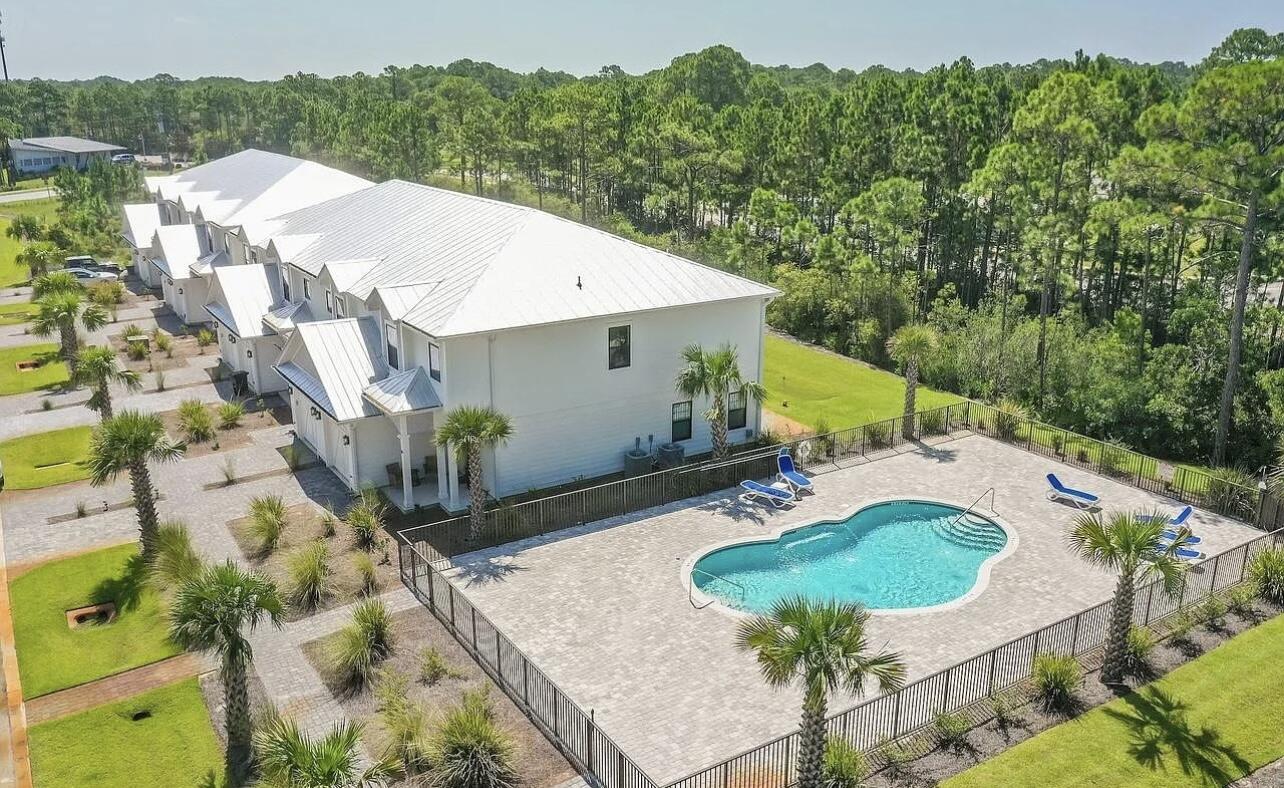 92 Heron's Crossing Santa Rosa Beach, FL 32459 - Photo 28 of 28 a backyard of a house with table and chairs