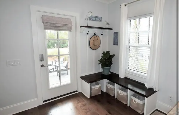 a hallway with window and flowerpot