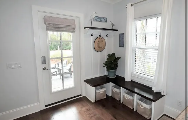 a hallway with window and flowerpot