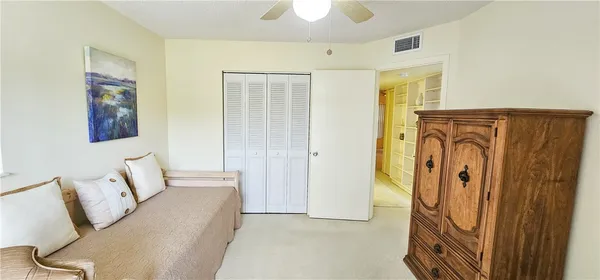 a spacious bedroom with a bed and a chandelier