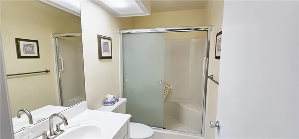 a bathroom with a shower and a toilet
