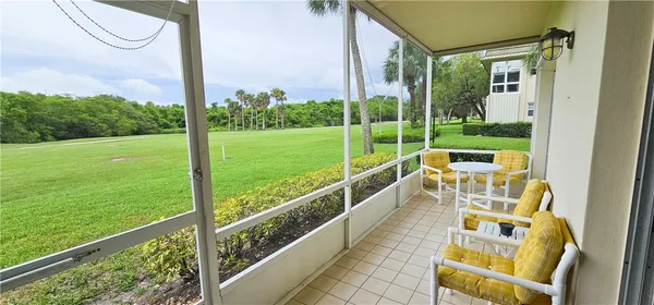 a view of balcony with two chairs and a table