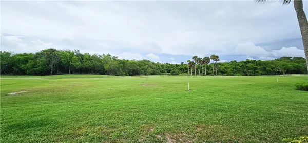 a view of a garden with a building in the background