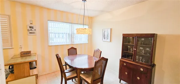 a view of a dining room with furniture and window
