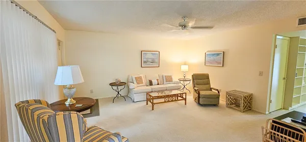 a living room with furniture and a lamp