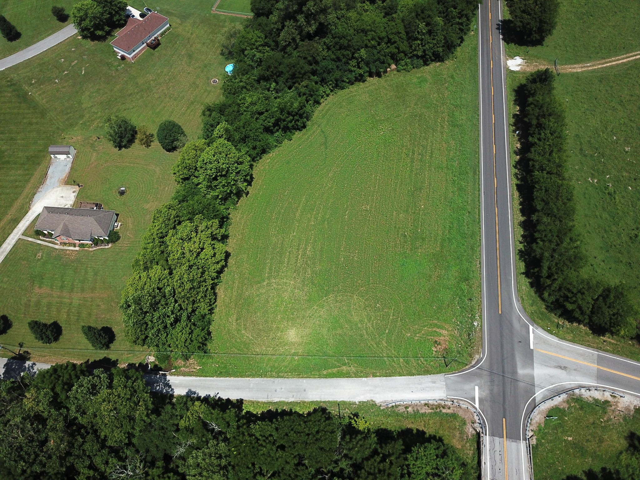 an aerial view of a residential houses with outdoor space and street view