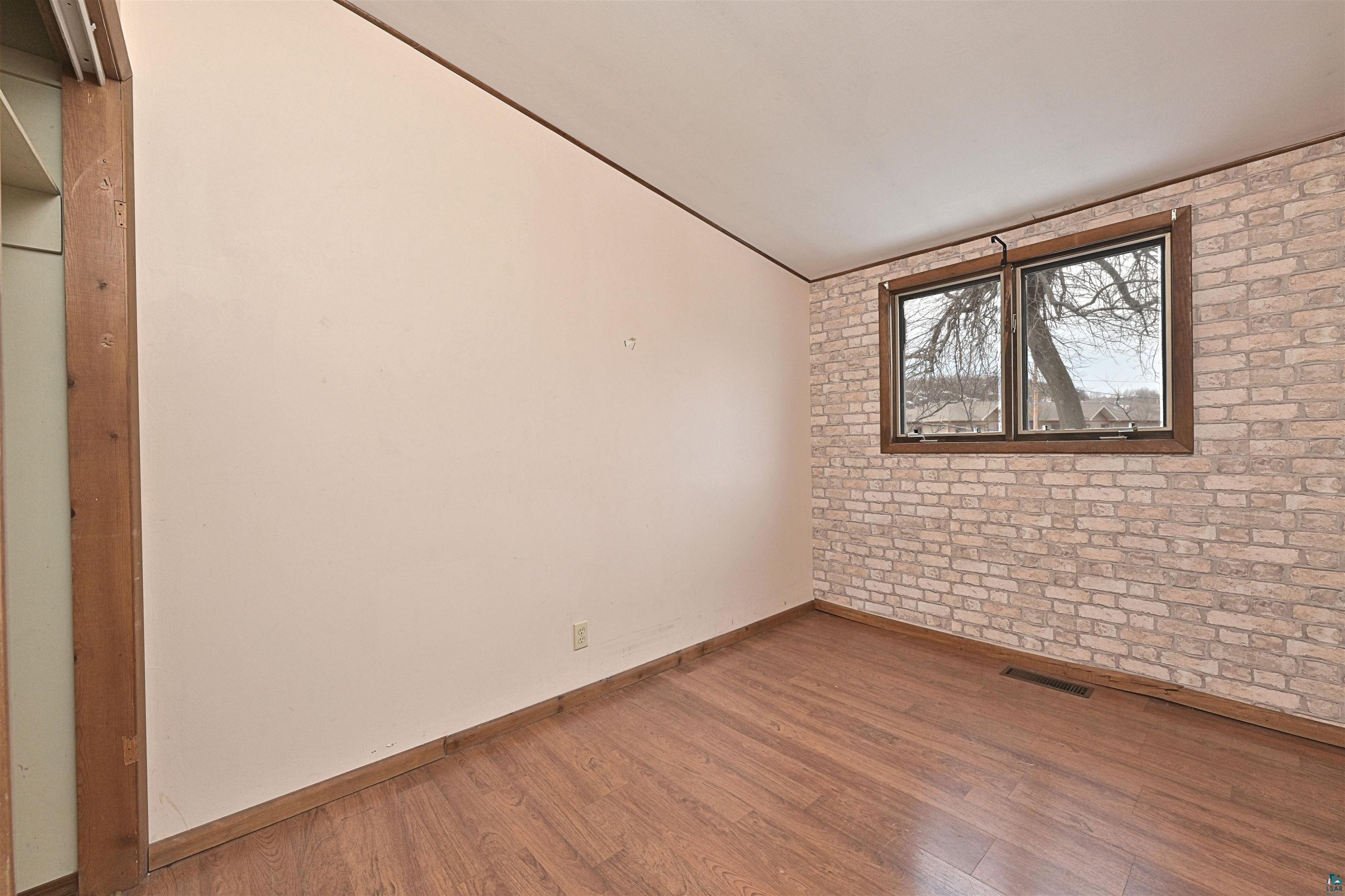 18 Banks Boulevard Silver Bay, MN 55614 - Photo 11 of 26 Unfurnished room with brick wall and wood finished floors