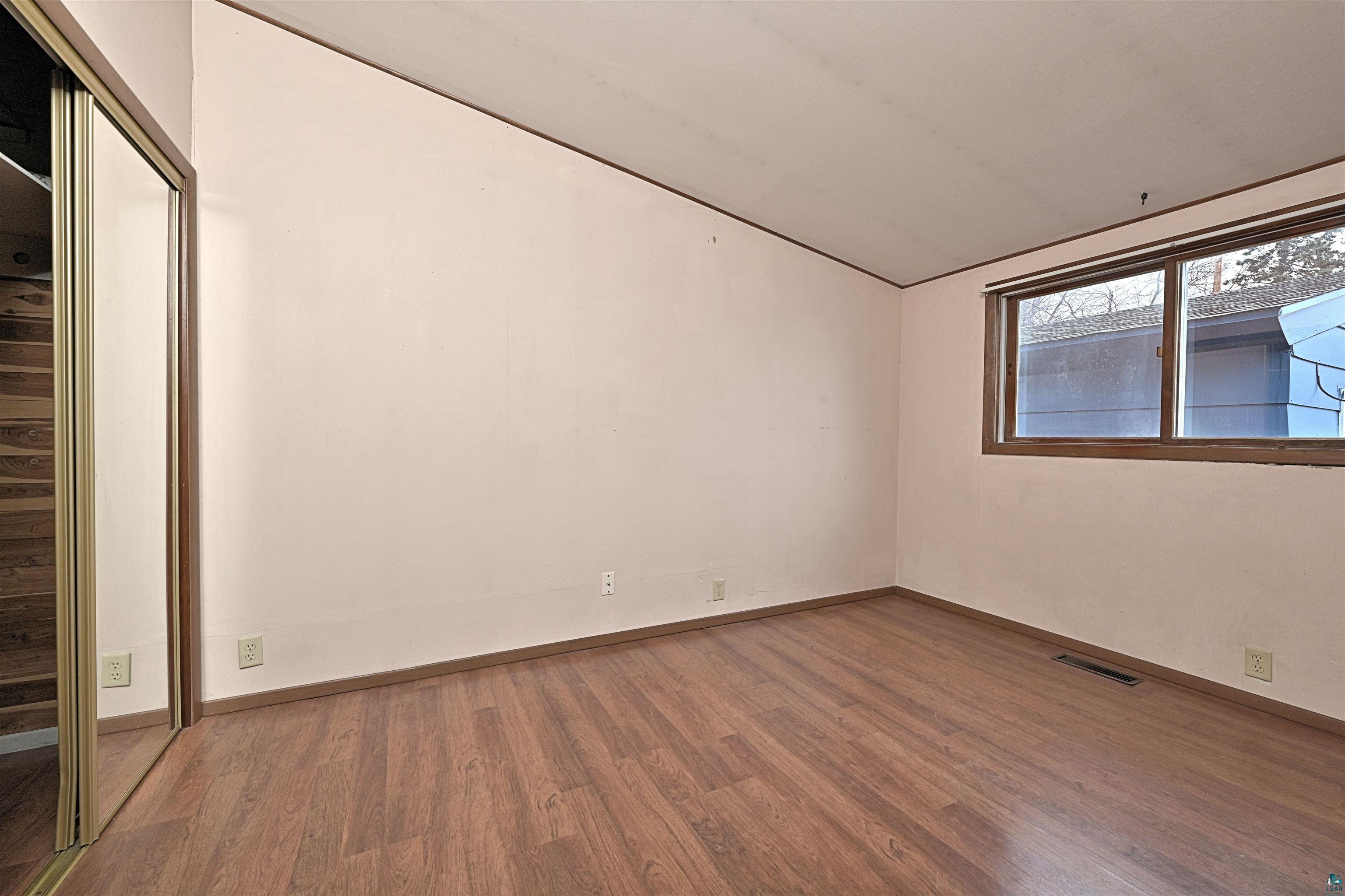 18 Banks Boulevard Silver Bay, MN 55614 - Photo 12 of 26 Unfurnished bedroom with wood finished floors, lofted ceiling, and a closet