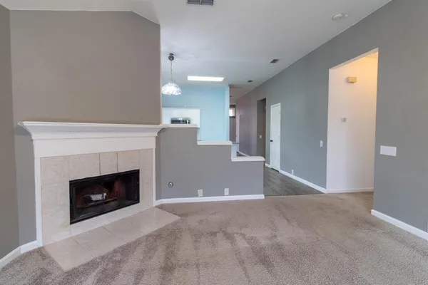 a view of an empty room with a fireplace