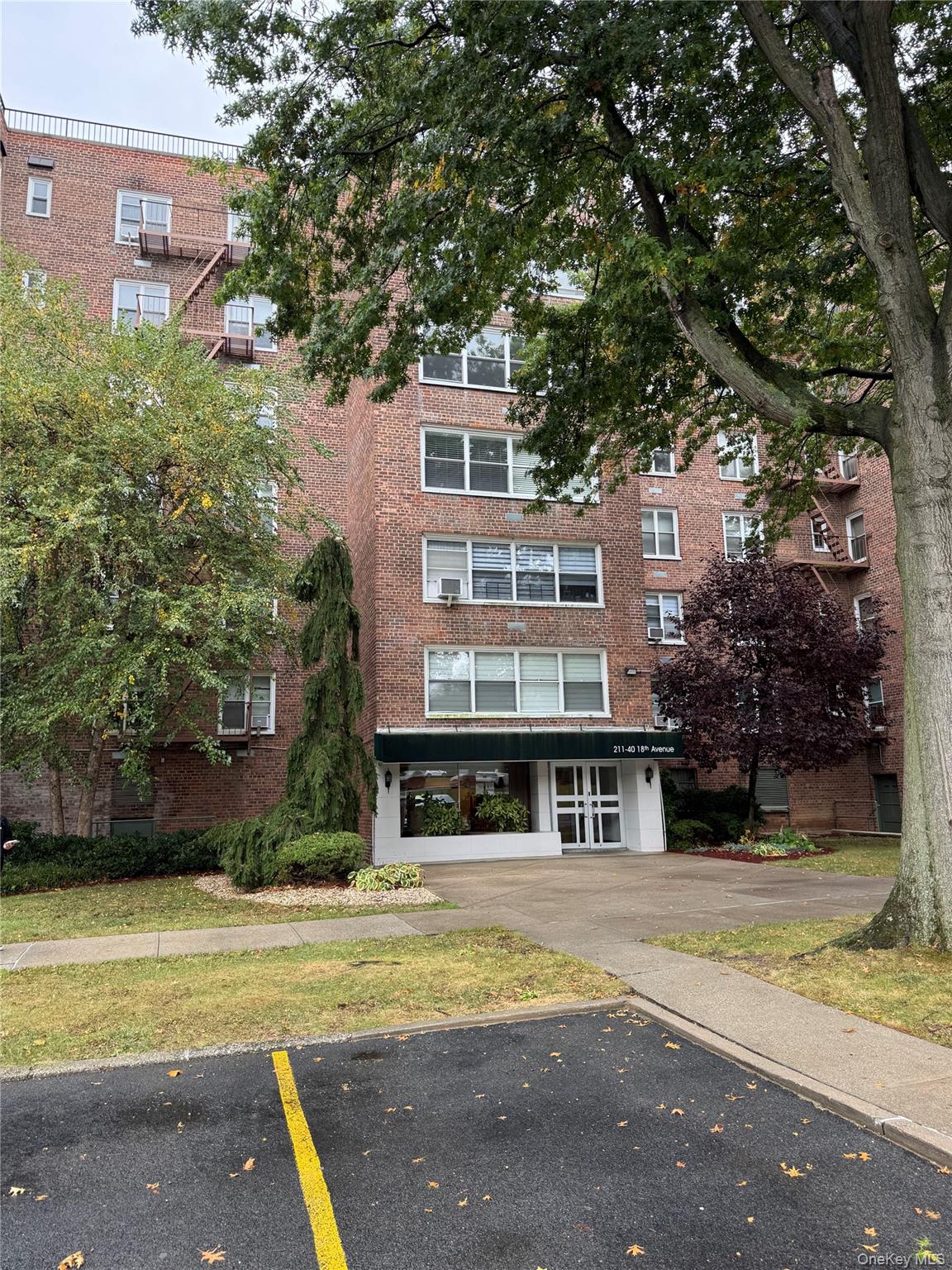 211-40 18th Avenue, Unit 4J Queens, NY 11360 - Photo 1 of 7 View of apartment building / complex