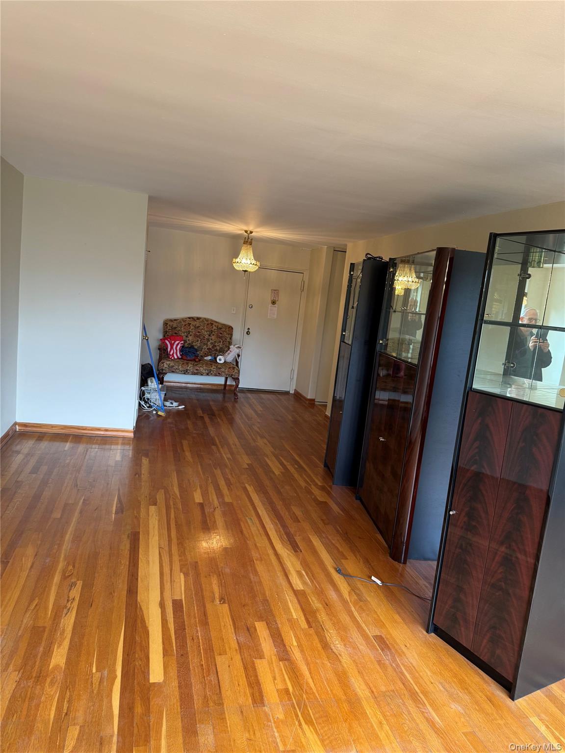 211-40 18th Avenue, Unit 4J Queens, NY 11360 - Photo 5 of 7 Living Room featuring light wood-type flooring and baseboards